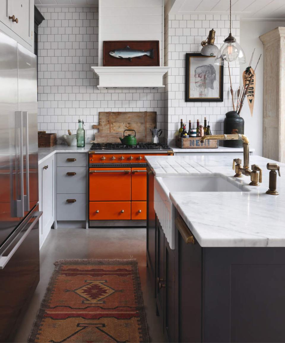White and gray kitchen with orange stove