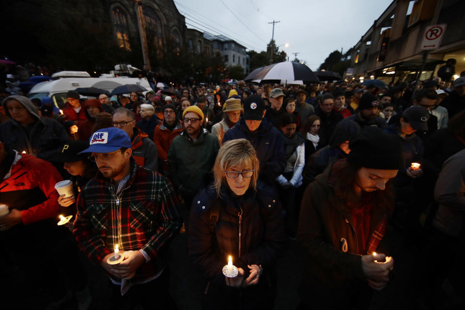 FILE - People hold candles as they gather for a vigil in the aftermath of a deadly shooting at the Tree of Life Congregation, in the Squirrel Hill neighborhood of Pittsburgh, Saturday, Oct. 27, 2018. Jury selection is scheduled to begin on Monday, April 24, for the suspect accused of invading the Tree of Life synagogue building on that Sabbath morning and murdering 11 worshippers from three congregations. (AP Photo/Matt Rourke, File)