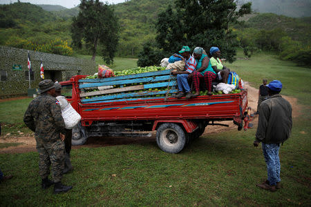 A member of the Dominican Armed Forces looks at a truck loaded with avocados and travellers on the border between the Dominican Republic and Haiti, at El Guacate military post, province of Independencia, Dominican Republic, October 2, 2018. REUTERS/Andres Martinez Casares