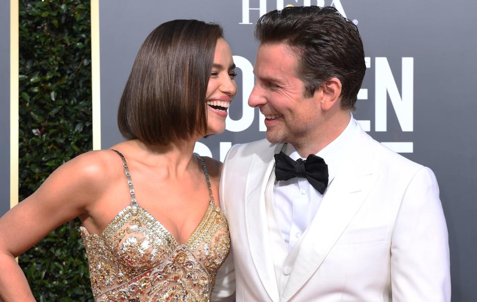 TOPSHOT - Best Actor in a Motion Picture  Drama and Best Director  Motion Picture for "A Star is Born" nominee Bradley Cooper (R) and his partner Russian model Irina Shayk arrive for the 76th annual Golden Globe Awards on January 6, 2019, at the Beverly Hilton hotel in Beverly Hills, California. (Photo by VALERIE MACON / AFP)        (Photo credit should read VALERIE MACON/AFP/Getty Images)