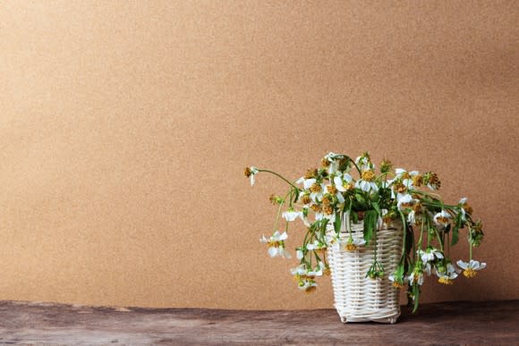 A basket holding wilted flowers