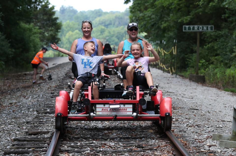 Jase Wamsley, 6, left, and his sister Jayden Wamsley, 7, were elated as they began the trip back to the starting point on a Rail Explorers railbike in Versailles, Ky. on July 27, 2023.   Their mom Micki Wamsley was in the background at left and their grandmother Lora Ginter was at right.  Riders were treated to a 10-mile round-trip scenic view of bourbon distilleries and horse farms in the area.