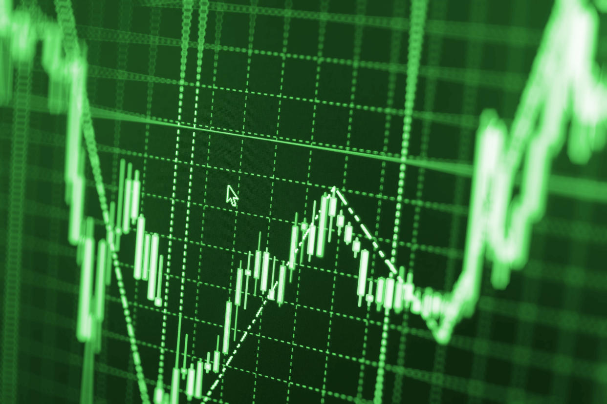 Stock market graph and bar chart price display. Data on live computer screen. Display of quotes pricing graph visualization. Abstract financial background trade colorful Stock exchange trade chart bar candles macro close-up. Shallow depth of field effect. Screen shows stock price rates live. Stock market quotes diagram on monitor.