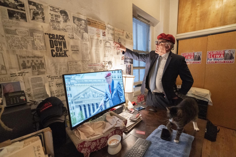 New York City Republican mayoral candidate Curtis Sliwa talks about newspaper clippings, police sketches and other mementos of his career hanging on a wall of his apartment, Tuesday, Oct. 12, 2021, in New York. (AP Photo/Mary Altaffer)