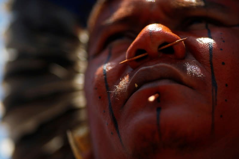 FILE PHOTO: An indigenous man from ethnic group Tupinamba attends a protest to defend indigenous land, outside Brazil's Supreme Federal Court in Brasilia