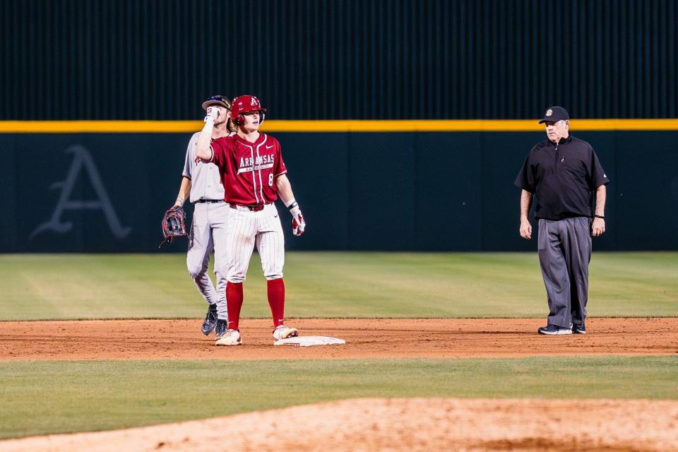 Arkansas baseball's Hudson White celebrates after a game-tying double in a 9-8 win over Texas Tech Tuesday, April 16, 2024.