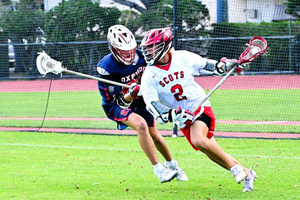 St. Andrews' Noah Smith outpaces his defender in a regional semifinal win against Oxbridge on May 1, 2024.