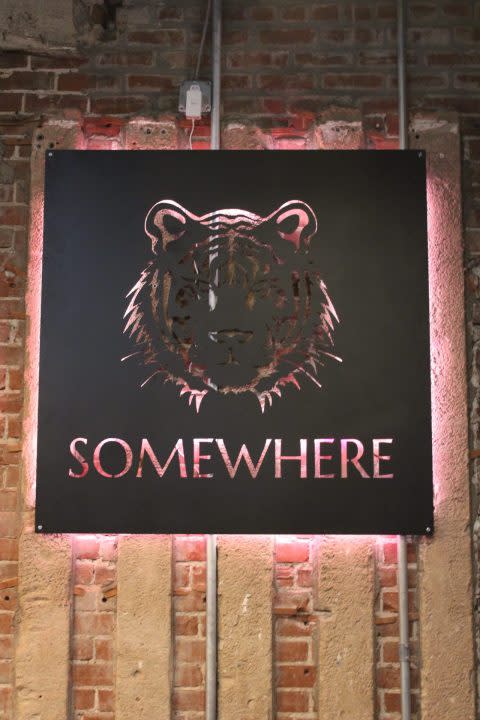 This picture shows a closeup of the sign for Somewhere Neighborhood Bar, 214 3rd Street.