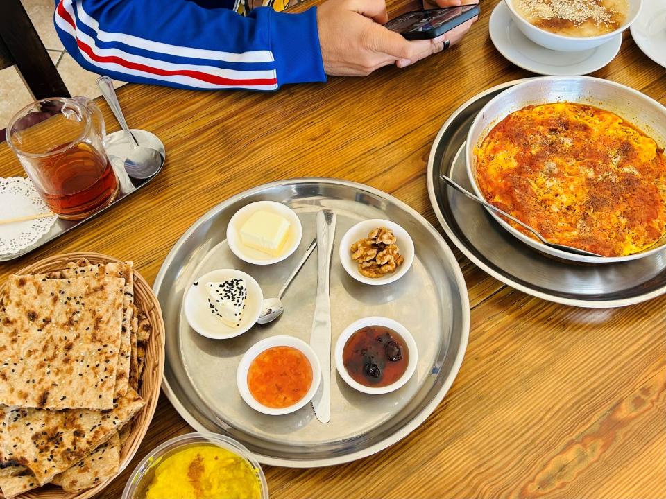 A breakfast spread at Ava Bakery in Phoenix, including sangak, various jams and cheese, an omelet and haleem.