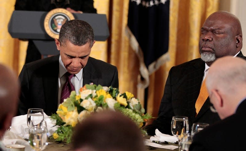 President Barack Obama, center, and others, lower their heads during a Easter Prayer breakfast with Christian leaders in the East Room of the White House, Tuesday, April 19, 2011. Seated to the right of Obama is Texas-based evangelist Bishop T.D. Jakes.