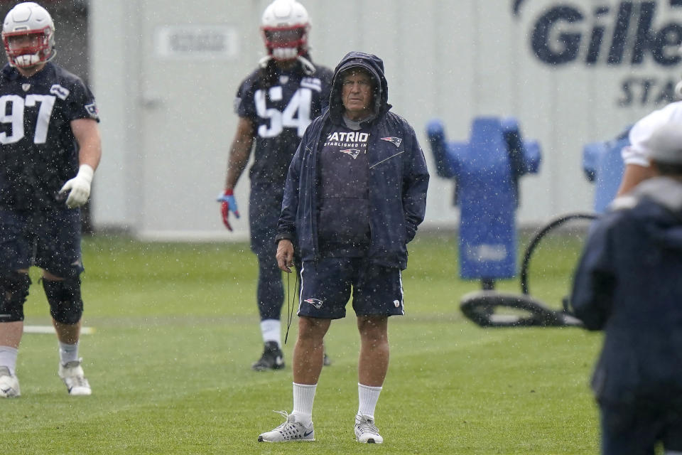 New England Patriots head coach Bill Belichick, center, stands on the field during an NFL football practice, Monday, June 14, 2021, in Foxborough, Mass. (AP Photo/Steven Senne)