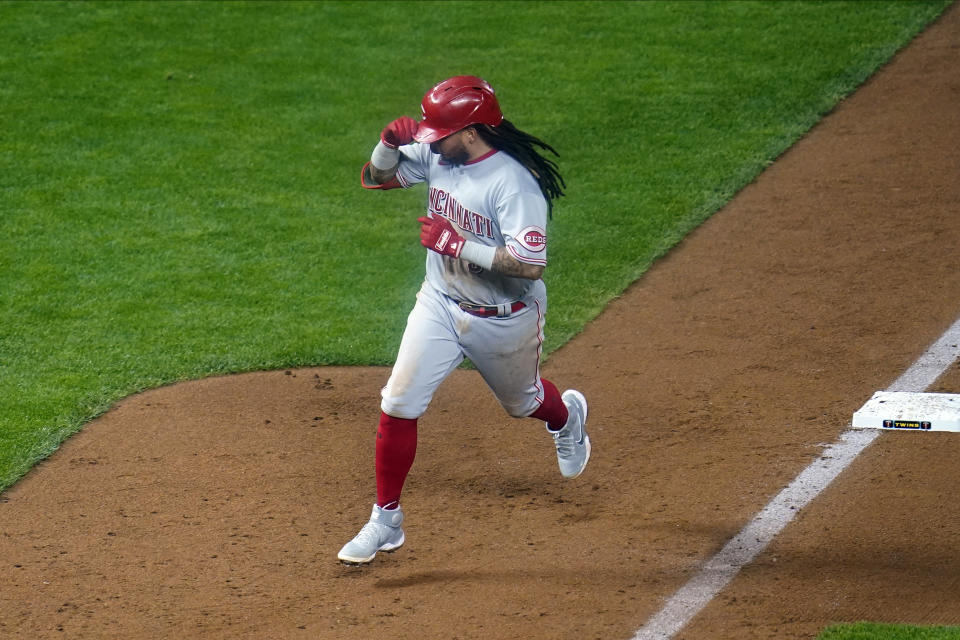 Cincinnati Reds' Freddy Galvis rounds third base on a solo home run off Minnesota Twins pitcher Jose Berrios during the fifth inning of a baseball game Friday, Sept. 25, 2020, in Minneapolis. (AP Photo/Jim Mone)