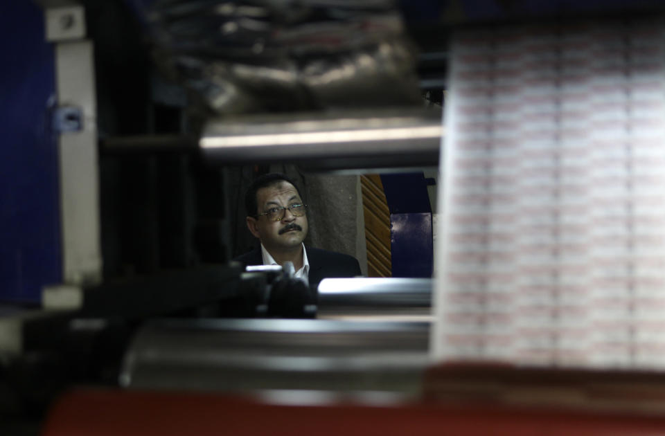 In this Monday, March 3, 2014 photo, Adel Abd ElSadk, owner of the pharmaceutical packaging company Trustpack, watches one of the machines at his factory which has been financed in part by loans from the Social Development Fund, located just outside Cairo, Egypt. The program, called “The Project” in Arabic, highlights entrepreneurship and small business acumen - something experts say is more crucial than ever as Egypt tries to claw its way out of tough economic times. (AP Photo/Amr Nabil)