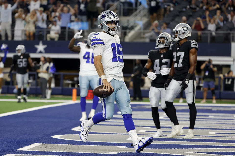 Dallas Cowboys quarterback Will Grier runs the ball for a touchdown as Las Vegas Raiders' Chris Smith II (42) and Sam Webb (27) look on in the second half of a preseason NFL football game in Arlington, Texas, Saturday, Aug. 26, 2023. (AP Photo/Michael Ainsworth)