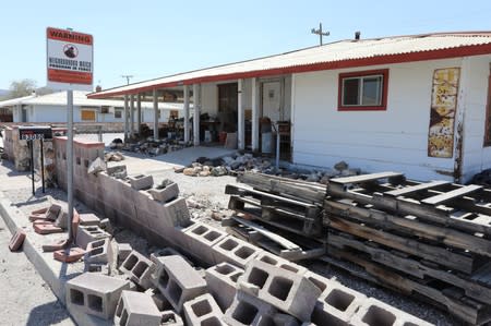 A wall next to a house is left in ruins after a powerful magnitude 7.1 earthquake broke, triggered by a 6.4 the previous day, near the epicenter in Trona, California