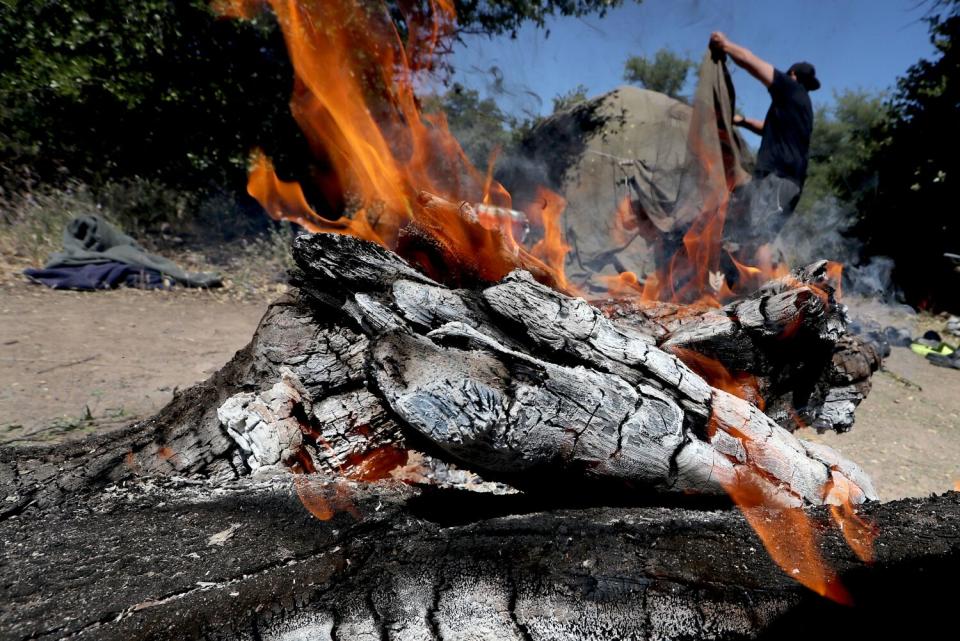 A campfire with a person in the background