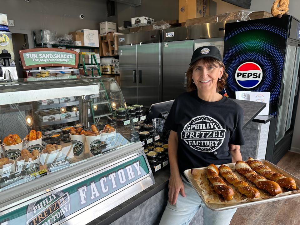 Bonnie Nach, co-owner of Philly Pretzel Factory on the Asbury Park Boardwalk, shows a tray of pretzel twists on May 2, 2024.