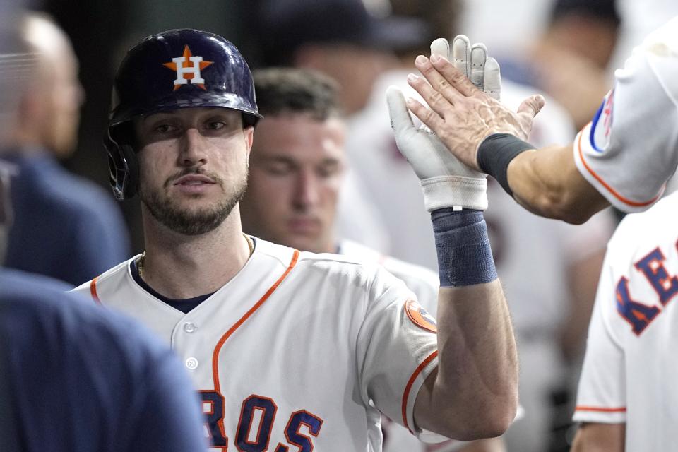 Houston Astros' Kyle Tucker celebrates in the dugout after hitting a home run against the Washington Nationals during the fifth inning of a baseball game Tuesday, June 13, 2023, in Houston. (AP Photo/David J. Phillip)