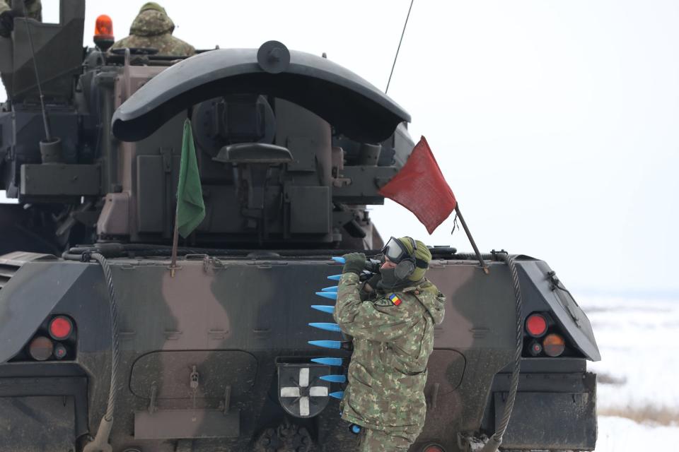 Romanian soldier carries rounds to a Gepard