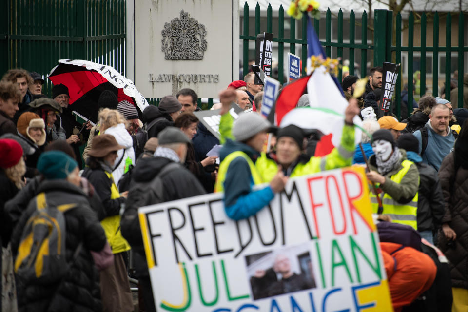 LONDON, ENGLAND - FEBRUARY 24: Protestors hold placards as they block the entrance to Woolwich Crown Court at Belmarsh prison prior to Julian Assange's extradition hearing on February 24, 2020 in London, England. Assange is wanted by the United States on charges related to the publication of classified US military documents and faces a possible maximum 175-year prison sentence. (Photo by Leon Neal/Getty Images)