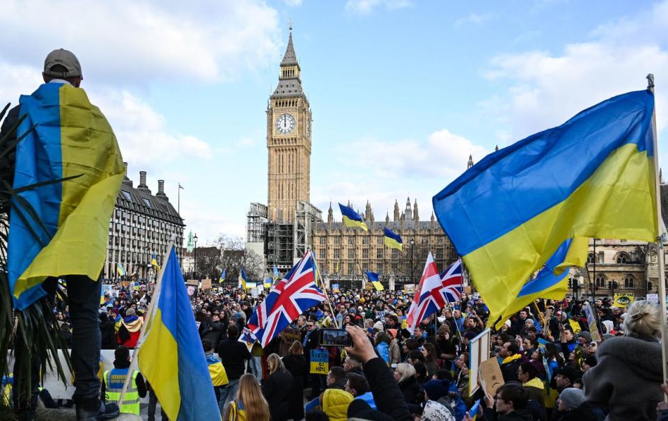 Demonstrators hold placards and Ukrainian and British flags during a protest rally for a Stop the War in Ukraine Global Day of Action, in central London, on March 6, 2022 as part of an international day of anti-war action, prompted by Russia's invasion of Ukraine.(Justin Tallis/AFP via Getty Images)