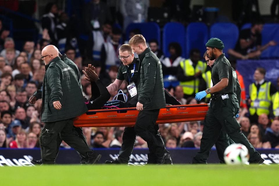 Bolt was stretchered off at Stamford Bridge (John Walton/PA Wire)