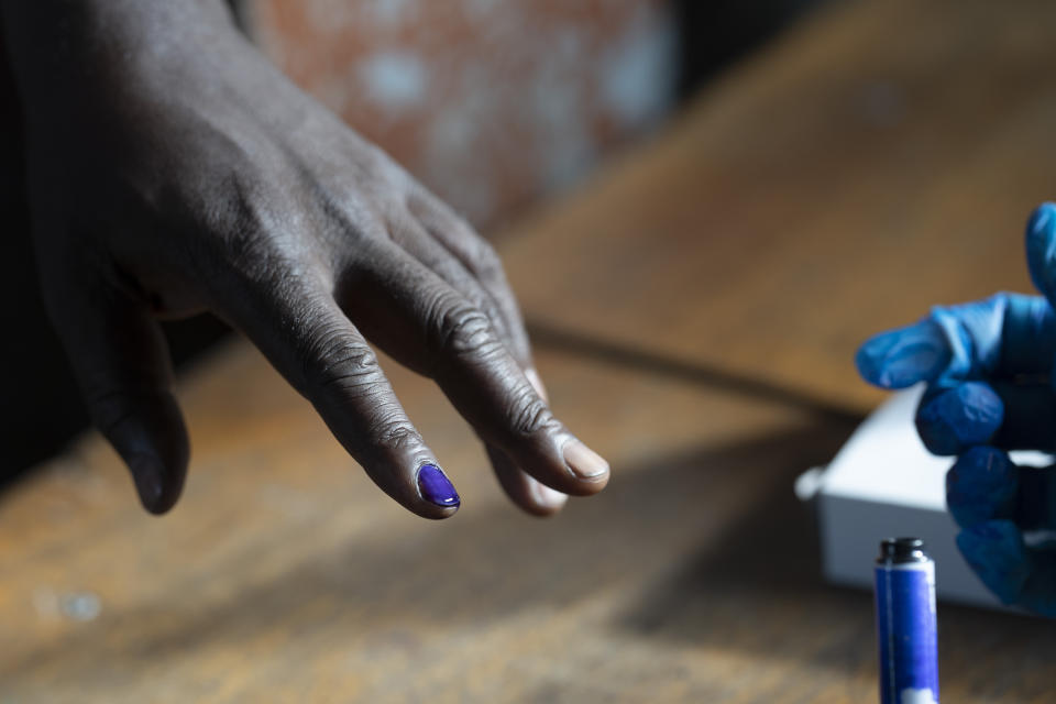 A man has his nail inked before casting his ballot for Gambia's presidential elections, in Banjul, Gambia, Saturday, Dec. 4, 2021. Lines of voters are forming outside polling stations in Gambia’s capital as the nation holds a presidential election. The election on Saturday is the first in decades without former dictator Yahya Jammeh as a candidate. (AP Photo/Leo Correa)