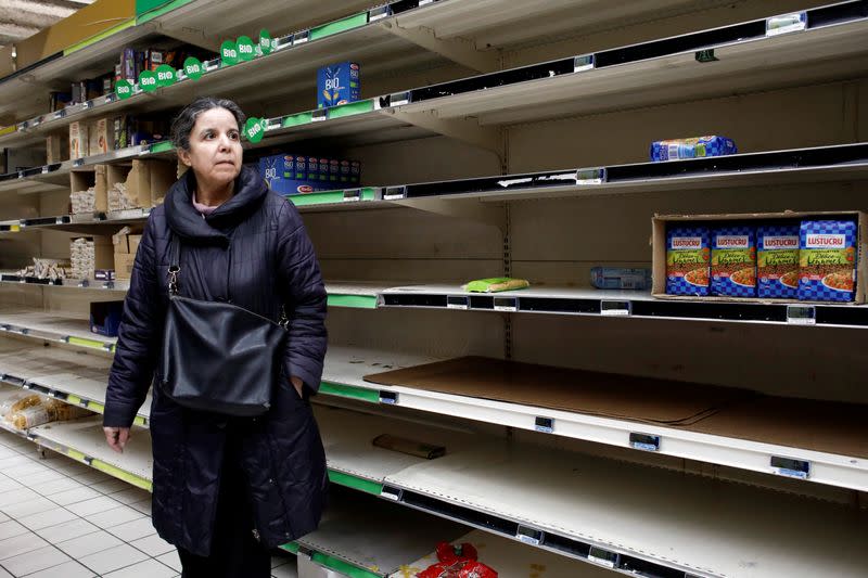 A view shows empty shelves at a Carrefour supermarket as people began stockpiling food in Gennevilliers, near Paris