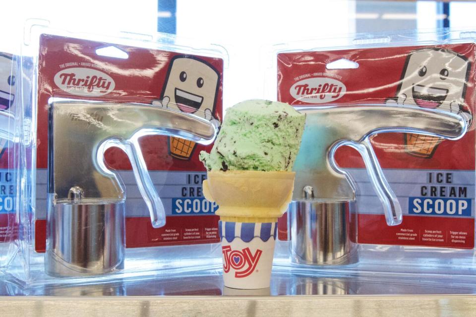 A mint chocolate chip ice cream cone flanked by Thrifty ice cream scoops at Rite Aid's Glassell Park location