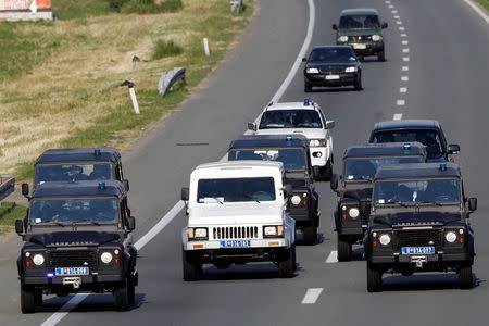 FILE PHOTO: Bosnian Serb wartime general Ratko Mladic in a white armoured vehicle is transported in a police convoy from a courthouse and jail complex to the airport in Belgrade, Serbia, May 31, 2011. REUTERS/Ivan Milutinovic/File Photo