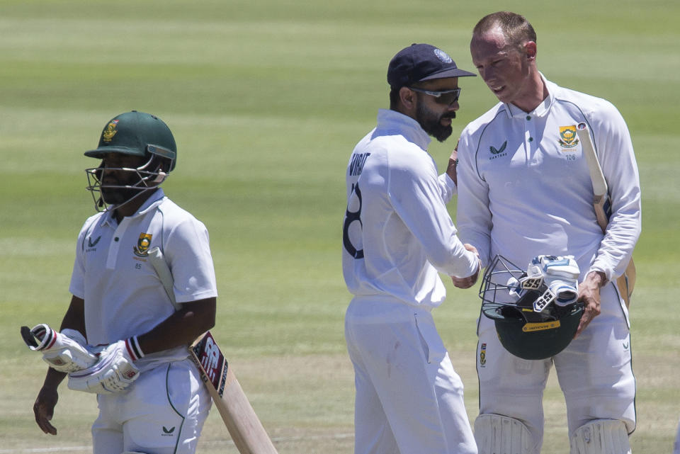 Indian captain Virat Kohli, center, congratulates Rassie van Der Dussen oafter South Africa beat India 2-1 in a test series between in Cape Town, South Africa, Friday, Jan. 14, 2022. (AP Photo/Halden Krog)