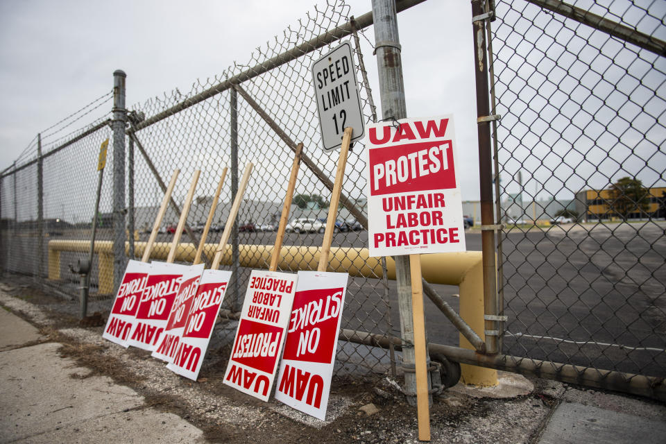 United Auto Workers protest signs lean against the fence at GM Powertrain in Bay City, Mich., on Monday, Sept. 16, 2019. (Kaytie Boomer/The Bay City Times via AP)