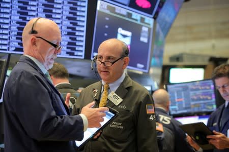 Traders work on the floor at the NYSE in New York