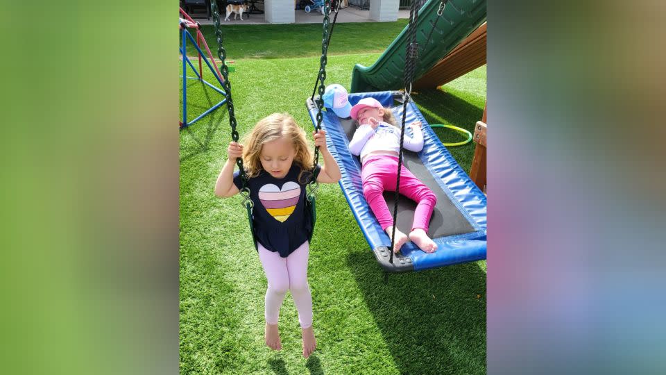 Keira and Olivia Riley at home in Phoenix. The swing set in their backyard was donated after Livvy requested it from the Make-A-Wish Foundation. Courtesy Kendra Riley - Courtesy Kendra Riley