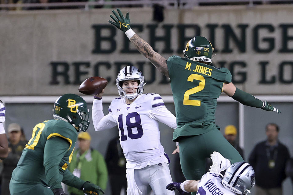 Kansas State quarterback Will Howard (18) looks to pass the ball past Baylor linebacker Matt Jones (2) in the second half of an NCAA college football game, Saturday, Nov. 12, 2022, in Waco, Texas. (AP Photo/Jerry Larson)