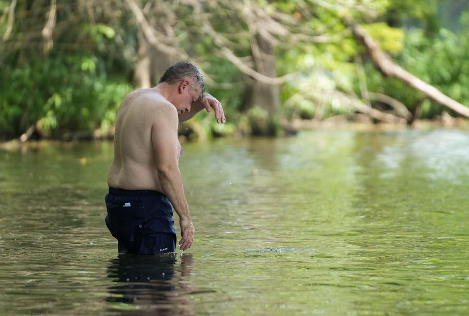 Edgar Del Angel cools off in Lady Bird Lake under the MoPac Boulevard bridge on a hot afternoon Monday. Some medications can make you more sensitive to heat or the sun and can cause you to dehydrate easily.