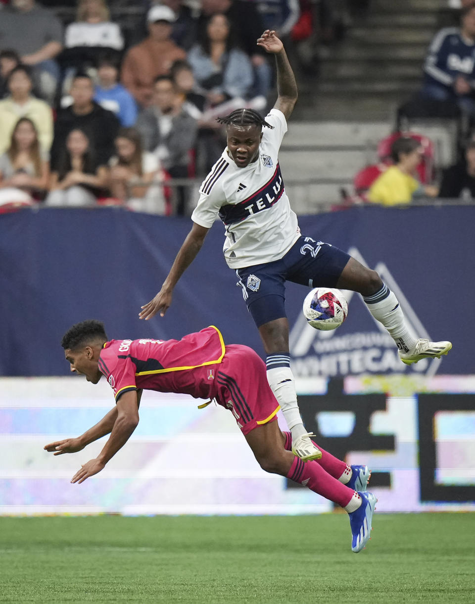 Vancouver Whitecaps' Javain Brown, top, and St. Louis City's Nicholas Gioacchini vie for the ball during the first half of an MLS soccer match Wednesday, Oct. 4, 2023, in Vancouver, British Columbia. (Darryl Dyck/The Canadian Press via AP)