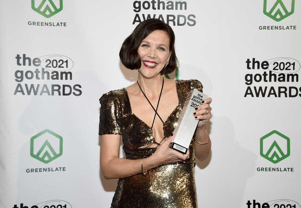 Maggie Gyllenhaal poses with the best screenplay award in the winners room at the Gotham Awards at Cipriani Wall Street on Monday, Nov. 29, 2021, in New York. (Photo by Evan Agostini/Invision/AP)