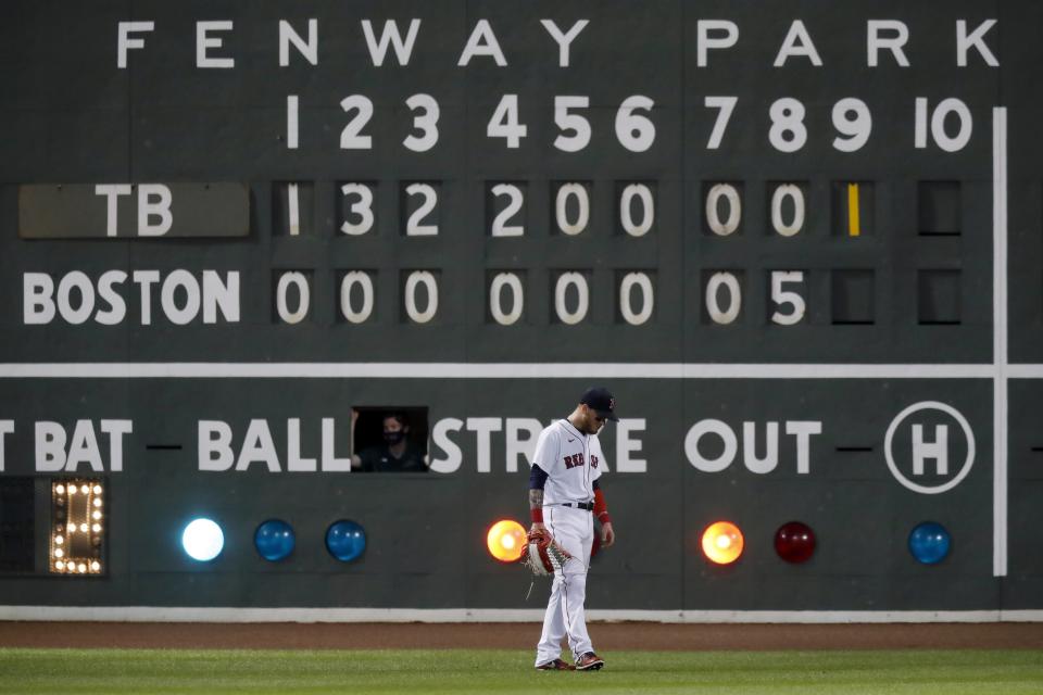 Boston Red Sox's Alex Verdugo stands in front of the left field scoreboard during the ninth inning of a baseball game against the Tampa Bay Rays, Wednesday, Aug. 12, 2020, in Boston. (AP Photo/Michael Dwyer)