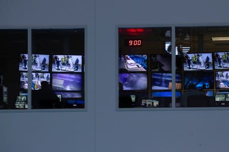 A control room full of video screens keeping watch over the underwater training at NASA's Neutral Buoyancy Laboratory (NBL) training facility near the Johnson Space Center in Houston,