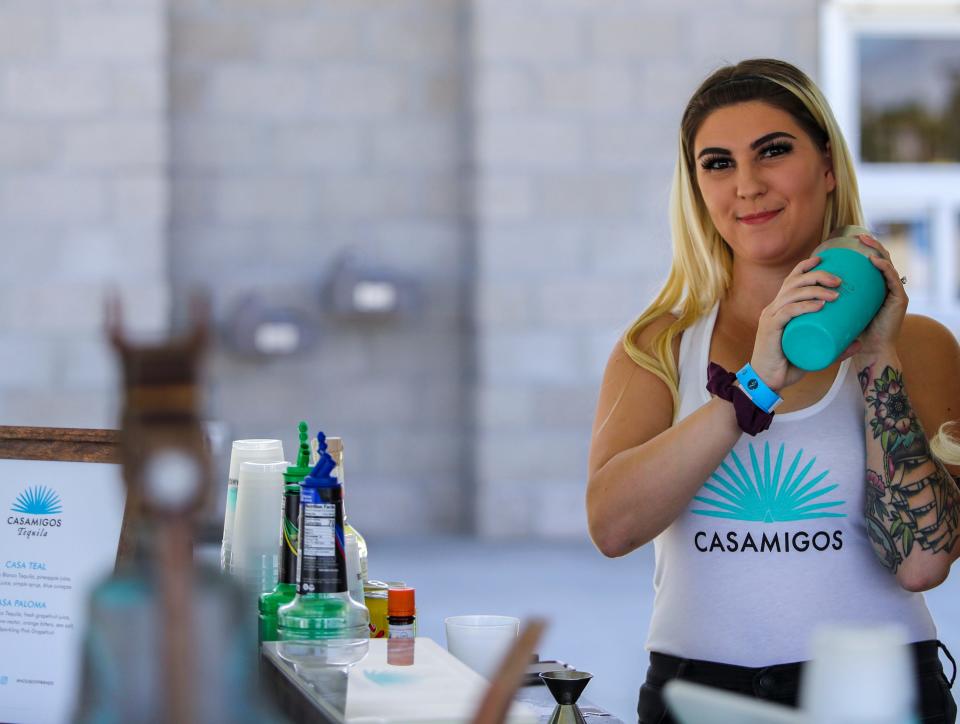Mixologist Riley Barden shakes a Paloma cocktail for a guest while working the Casamigos bar during the Taste of Jalisco Festival in Cathedral City, Calif., Saturday, Feb. 4, 2023. 