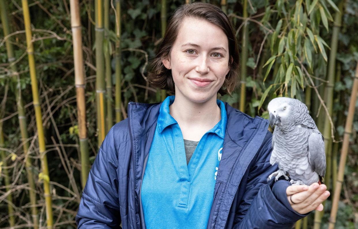 Roane State student Kinsley Cagle poses with "Einstein," the Zoo Knoxville parrot who has become a YouTube sensation with over 24 million views.