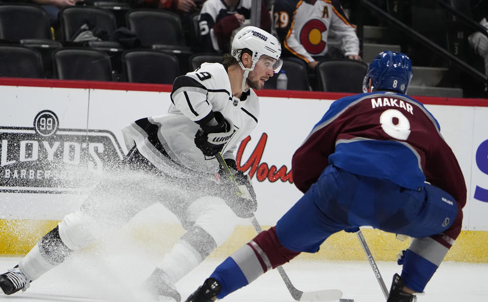 Los Angeles Kings right wing Adrian Kempe, left, looks to pass the puck as Colorado Avalanche defenseman Cale Makar, right, drops back to cover in the second period of an NHL hockey game Friday, Jan. 26, 2024, in Denver. (AP Photo/David Zalubowski)