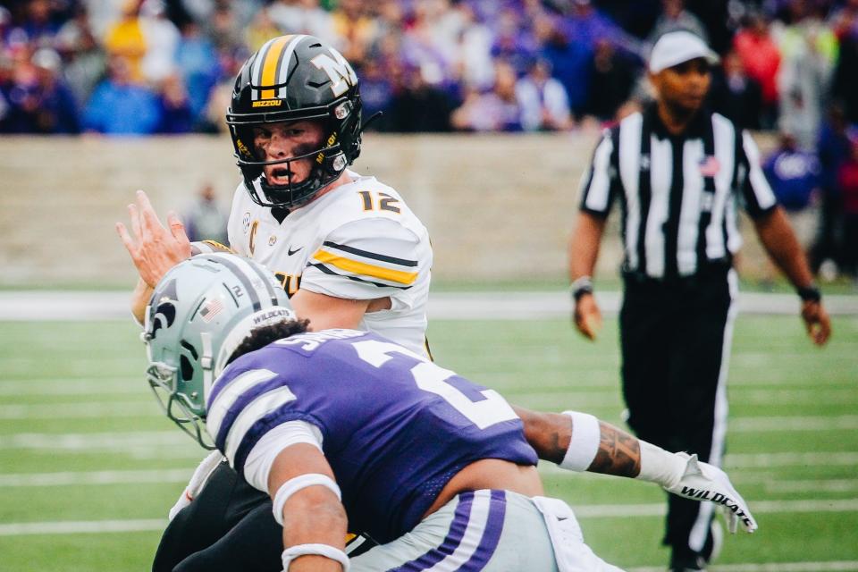 Kansas State safety Kobe Savage moves in for a hit on Missouri quarterback Brady Cook (12) during last year's game at Bill Snyder Family Stadium in Manhattan.