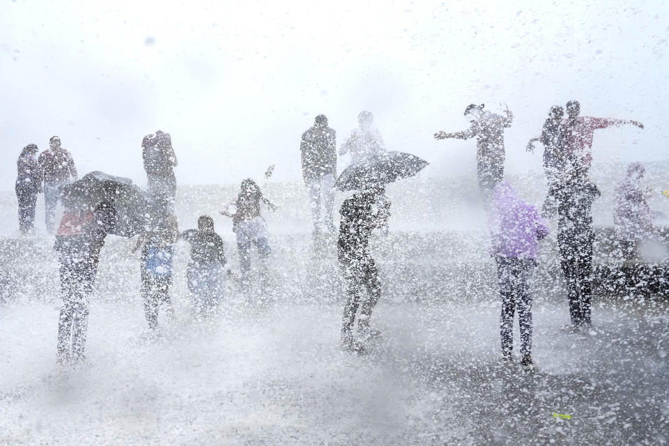 People enjoy high tide waves on the Arabian Sea coast in Mumbai, India, Thursday, July 6, 2023.(AP Photo/Rajanish Kakade)