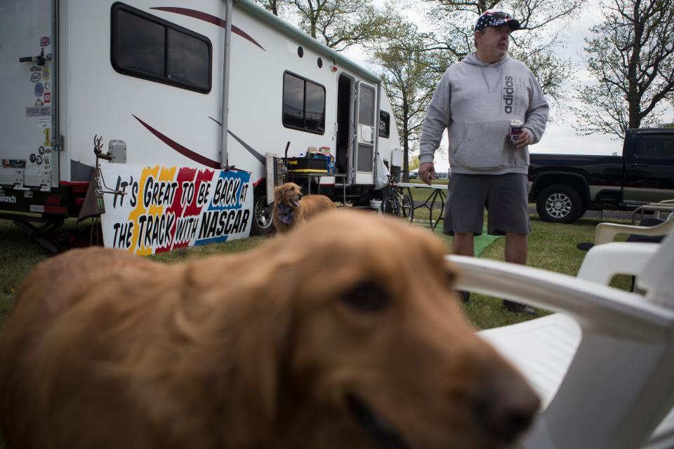 NASCAR fan Steven Douse hangs out at his campsite with his wife Beth Daus and their dogs ahead of the races this weekend Wednesday, April 27, 2022. Daus has been coming to he NASCAR races in Dover for 18 years. 