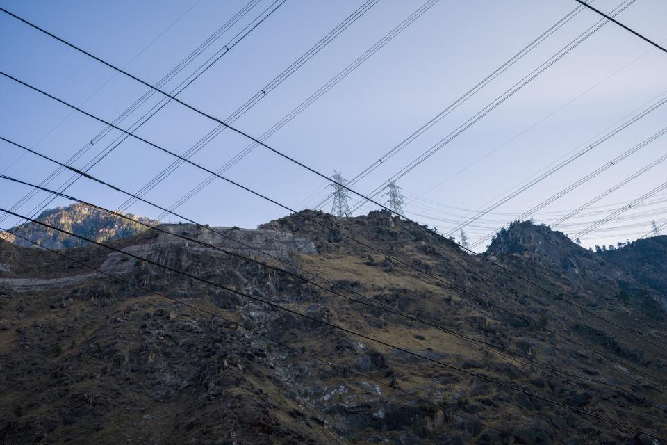 Power cables and pylons are visible in the Kinnaur district of the Himalayan state of Himachal Pradesh, India, Wednesday, March 15, 2023. A favorite initiative of Indian governments, the push for dams has skyrocketed as the nation looks for round-the-clock energy that doesn't spew planet-warming emissions. (AP Photo/Ashwini Bhatia)