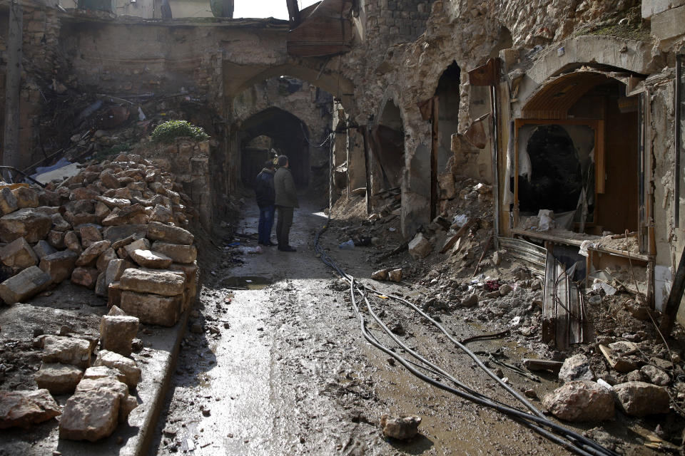 FILE - Syrian men check the destruction of the old market in the old city of Aleppo, Syria, Thursday, Jan. 18, 2018. For years, the people of Aleppo bore the brunt of bombardment and fighting when their city, once Syria's largest and most cosmopolitan, was one of the civil war's fiercest battle zones. Even that didn't prepare them for the new devastation and terror wreaked by this week's earthquake. (AP Photo/Hassan Ammar, File)