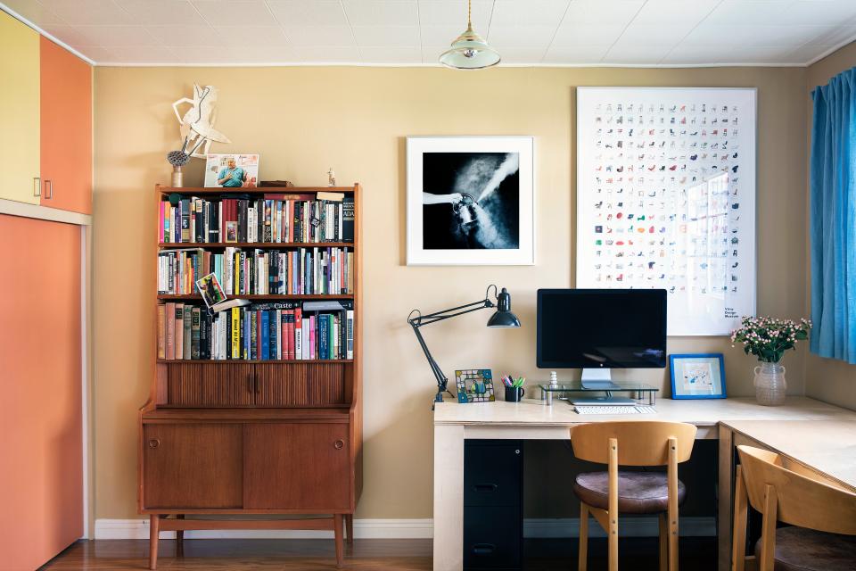 In the home office, a midcentury Dutch cabinet from Adam’s family sits with custom desks and a photograph by Ryan Harrison Gould. The chairs are vintage IKEA from the 1970s.