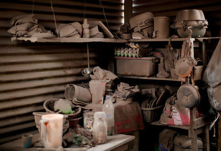 Kitchen shelves are covered with ash after the eruption of the Fuego volcano at San Miguel Los Lotes in Escuintla, Guatemala, June 6, 2018. REUTERS/Carlos Jasso